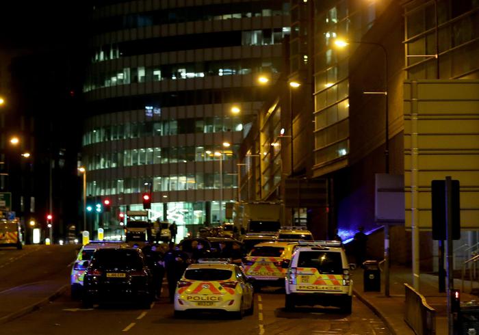 epa05982573 Emergency vehicles are seen outside the Manchester Arena following reports of an explosion, in Manchester, Britain, 23 May 2017. According to a statement released by the Greater Manchester Police on 23 May 2017, police responded to reports of an explosion at Manchester Arena on 22 May 2017 evening. At least 19 people have been confirmed dead and others 50 were injured, authorities said. The happening is currently treated as a terrorist incident until police know otherwise. According to reports quoting witnesses, a mass evacuation was prompted after explosions were heard at the end of US singer Ariana Grande's concert in the arena.  EPA/NIGEL RODDIS