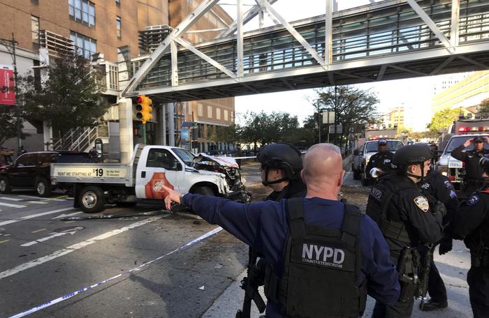 New York City Police Officers respond to a report of gunfire along West Street near the pedestrian bridge at Stuyvesant High School in lower Manhattan in New York, Tuesday, Oct. 31, 2017. (Martin Speechley/NYPD via AP)