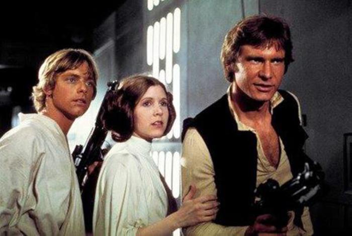 This photo provided by Twentieth Century Fox Home Entertainment shows, Mark Hamill, from left, as Luke Skywalker, Carrie Fisher as Princess Leia Organa, and Harrison Ford as Hans Solo in the original 1977 "Star Wars: Episode IV - A New Hope." The  four-day Star Wars Celebration kicked off Thursday, April 14, 2017 in Orlando, Fla., marking the 40-year anniversary of Lucas space saga. (Twentieth Century Fox Home Entertainment via AP)