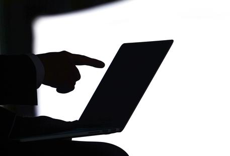 epa04793144 A participant points to his laptop screen before the start of the Potsdam Conference for National Cyber Security at the Hasso Plattner Institute in Potsdam,??Germany, 11 June 2015. Representatives form politics, administration, economics, and science are convening to discuss courses of action in cyber security at the conference, which is taking place for the third time.  EPA/RALF??HIRSCHBERGER