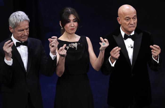 Italian singer and Sanremo Festival artistic director Claudio Baglioni (L). Italian actress Virginia Raffaele (C) and Italian actor Claudio Bisio (R) on stage at the Ariston theatre during the 69th Sanremo Italian Song Festival, Sanremo, Italy, 06 February 2019. The Festival runs from 05 to 09 February. ANSA/RICCARDO ANTIMIANI