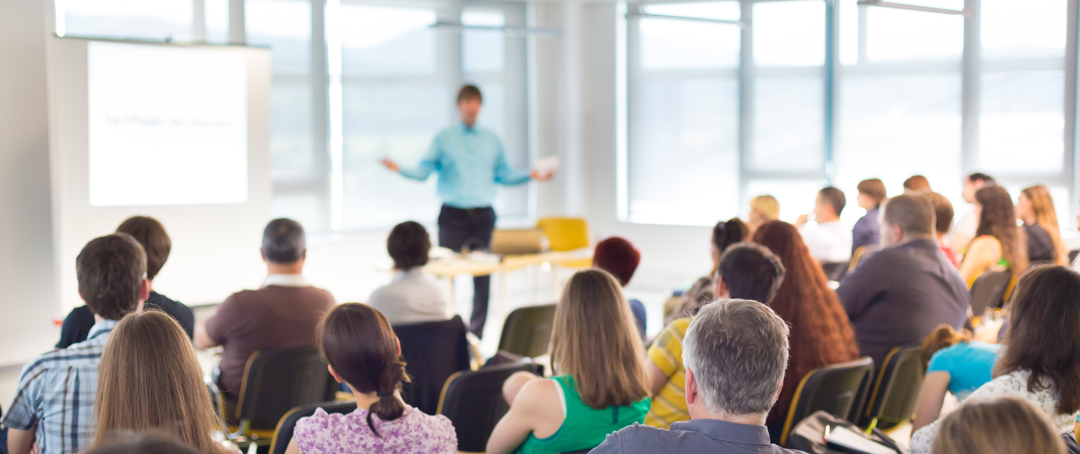 Speaker at business workshop and presentation. Audience at the conference room.