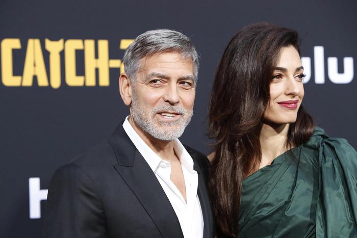 epa07554810 US actor/cast member George Clooney and his wife Amal Clooney arrive for the premiere of Hulu's 'Catch 22' at the TCL Chinese Theatre IMAX in Hollywood, Los Angeles, California, USA, 07 May 2019. The movie opens in US theaters on 17 May 2019.  EPA/NINA PROMMER