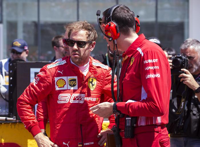 Ferrari driver Sebastian Vettel, left, of Germany, awaits the Formula One Canadian Grand Prix auto race in Montreal on Sunday, June 9, 2019. (Paul Chiasson/The Canadian Press via AP)