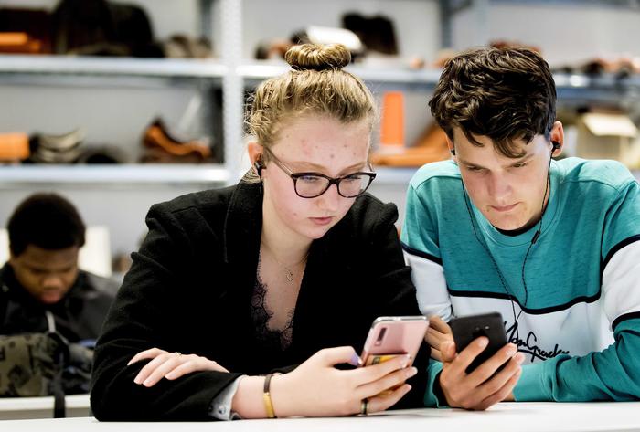 epa07645659 Students of the ROC Amsterdam watch a lesson on their smartphone, in Amsterdam, the Netherlands, 13 June 2019. Klassewerk is a new teaching method in which professionals give practical lessons to MBO students via Instagram Live.  EPA/Koen van Weel